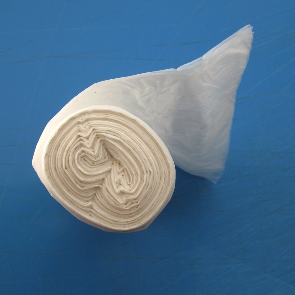 Trash C_an Liners. (1) Roll of 100 bags,  Clear TRASH BAGS  Size 6 1/2" x  30"